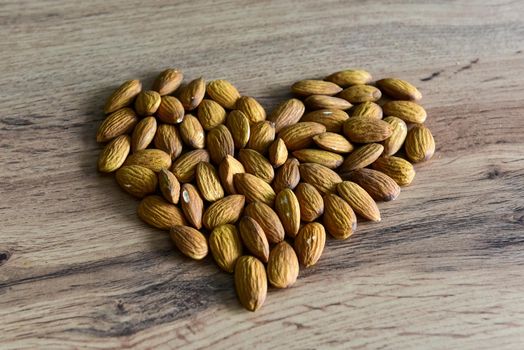 Almonds lying on the table in the form of a heart.