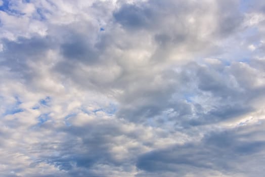 blue sky background with cumulus white clouds.