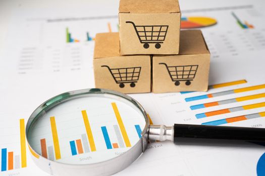 Shopping cart logo on box with magnifying glass on graph background. Banking Account, Investment Analytic research data economy, trading, Business import export transportation online company concept.