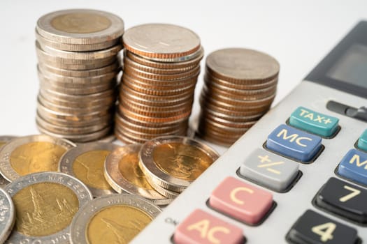 Coins on calculator and graph paper. Finance development, Banking Account, Statistics, Investment Analytic research data economy, Stock exchange trading, Business company concept.