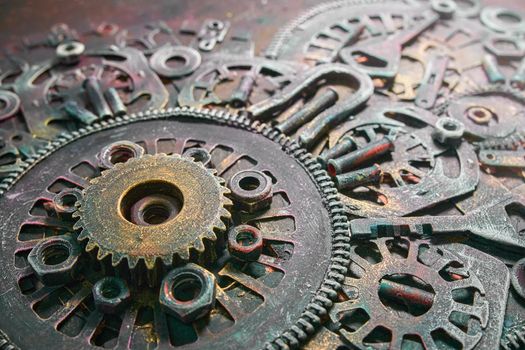 Machine gear, metal cogwheels, nuts and bolts and keys.Gears cogs motion metal industrial background.Selective focus.