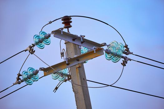The top of electric pole on blue sky background