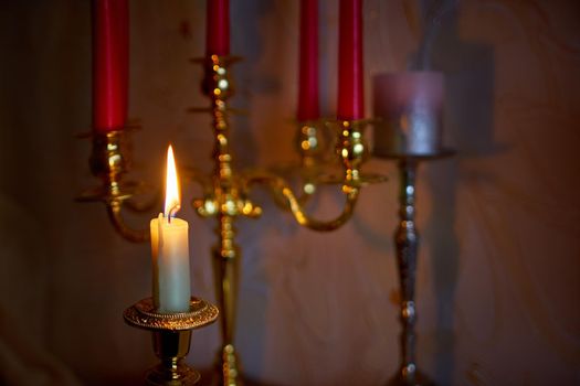 Candles to a beautiful candlestick. Candles lighting in the dark night