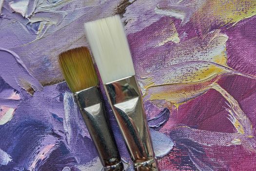 brush on a painted abstract background.The top view. Tools for hobby or education. Arts.Close-up.