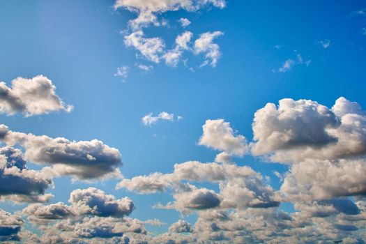 Blue sky with white clouds on a summer day, background