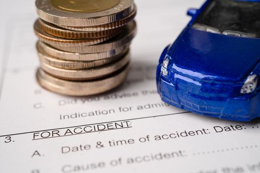 car and coins on Insurance claim accident car form background, Car loan, Finance, saving money, insurance and leasing time concepts.