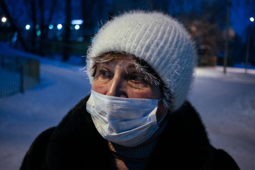 Adult woman winter portrait with face mask