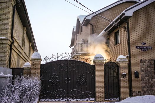 House gate and smoke in winter
