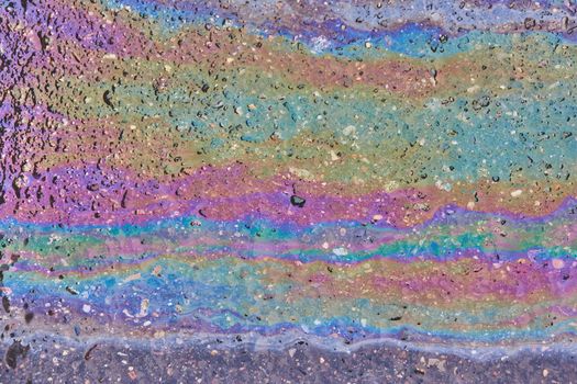 Oil stain on Asphalt, color Gasoline fuel spots on Asphalt Road as Texture or Background