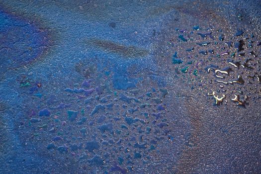 Oil stain on Asphalt, color Gasoline fuel spots on Asphalt Road as Texture or Background.Close-up Oil stain on Asphalt