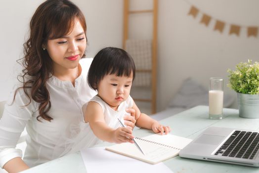 Mother and daughter are learning to write.