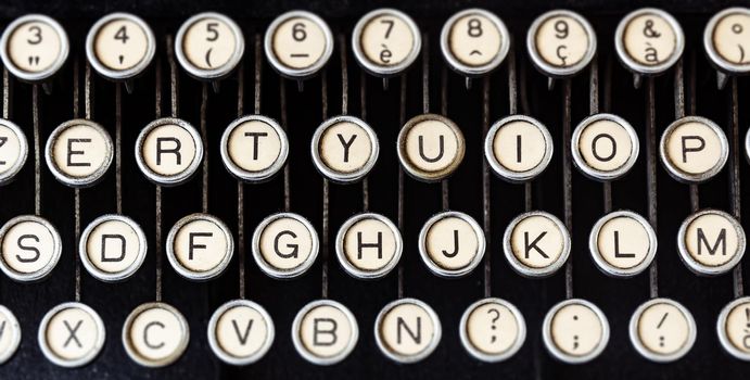 Round keys of an old typewriter seen from above. Mechanical tools for writing. Old time journalism