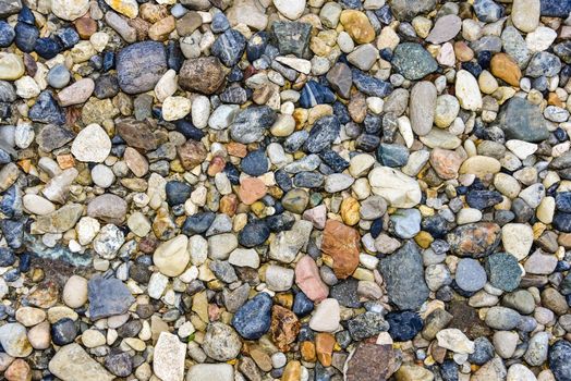 Rocks sea beach or stones background, Top view many small stones in assorted colors, Abstract rough wallpaper nature concept.