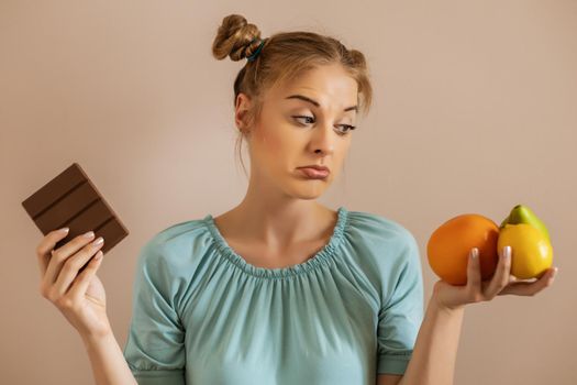 Cute woman is tired of dieting and  eating fruit.Toned image.