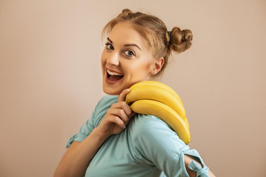 Portrait of cute happy woman holding bananas.