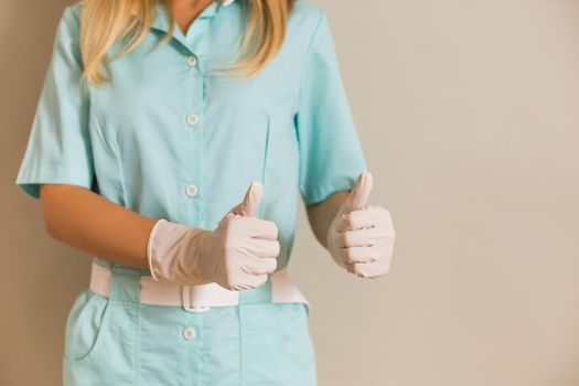 Image of medical nurse showing thumbs up.