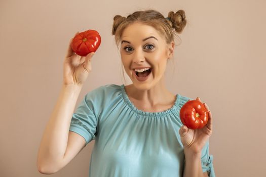 Portrait of cute happy woman holding tomato.Toned image.