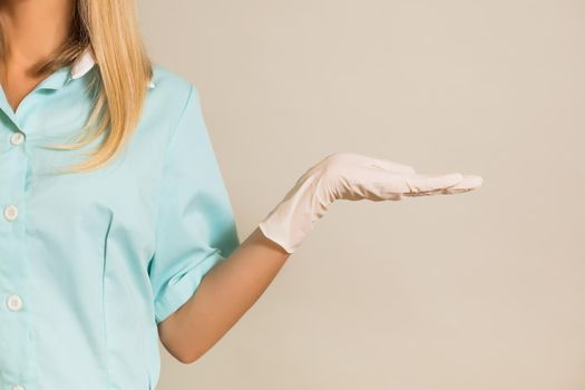 Image of medical nurse showing palm of hand.