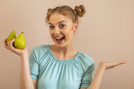 Portrait of happy cute woman holding pears and gesturing.