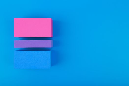 Flat lay with bisexual pride flag made of colorful blocks on blue background. Concept of lgbtq plus community, Pride month, sexual minorities and tolerance