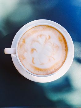 Cappuccino in summer cafe outdoors.