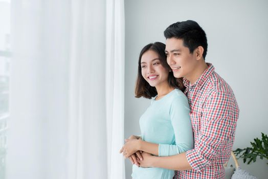 Romantic happy young asian couple relax at modern home indoors