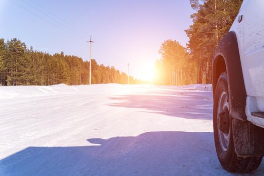 car on a winter road. Adventure. car on winter snowy road in mountains in sunny day.