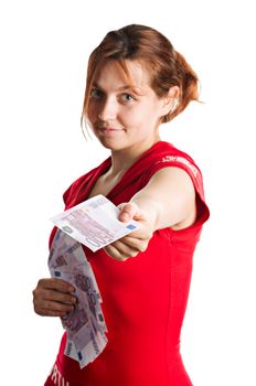 Red-haired girl holding bunch of euro bills and offering one