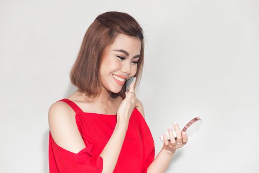 Fashion lifestyle portrait of young asian woman holding foundation cosmetic product 
