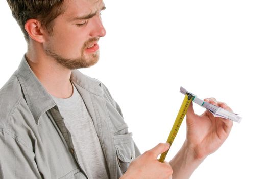 Man's hands measuring stack of 500 euro bills