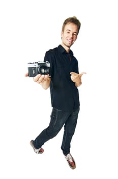 Young man standing with film camera isolated on white background