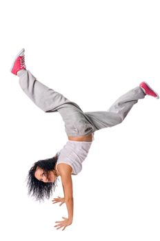 Beautiful fit girl making handstand isolated on white background