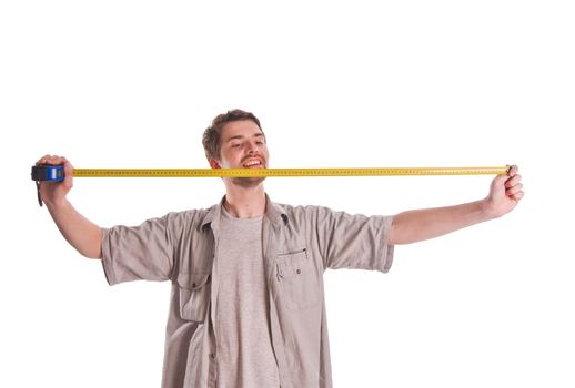 Young man measuring something with ruler on white