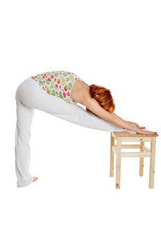 Red haired girl performing fitness exercises on white background