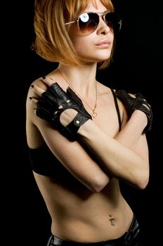 Studio shot of beautiful red girl wearing leather gloves