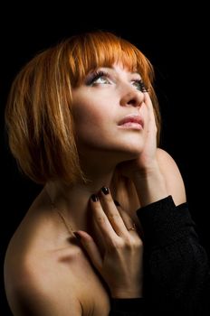 Studio shot of beautiful red girl on black background