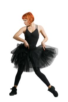 Beautiful red-haired ballerina wearing tutu on white background