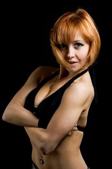 Studio shot of beautiful fitness instructor on black background