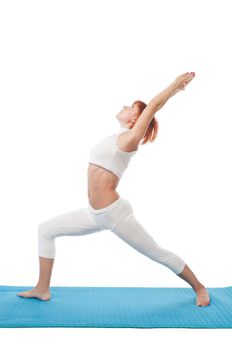 Beautiful red-haired girl practicing yoga or callanetics on white background