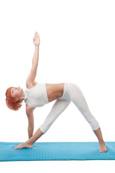 Beautiful red-haired girl practicing yoga or callanetics on white background