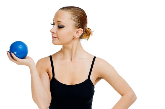 Beautiful fit red girl working out with blue ball