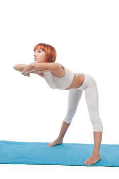 Beautiful red-haired girl practicing yoga or callanetics on white background