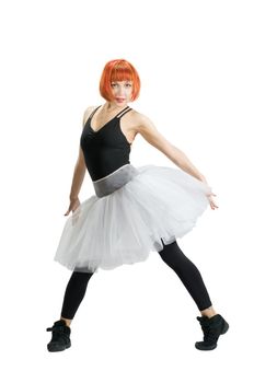 Beautiful red-haired ballerina wearing tutu on white background