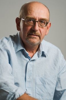 Handsome mature man posing on plain background