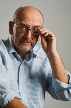 Handsome mature man posing on plain background