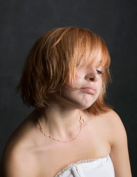 Portrait of a beautiful red haired girl on black background