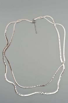 Luxury silver necklace on gray background