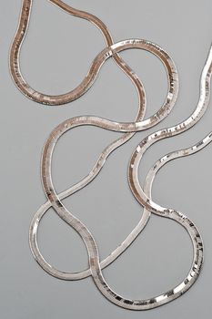 Luxury silver necklace on gray background