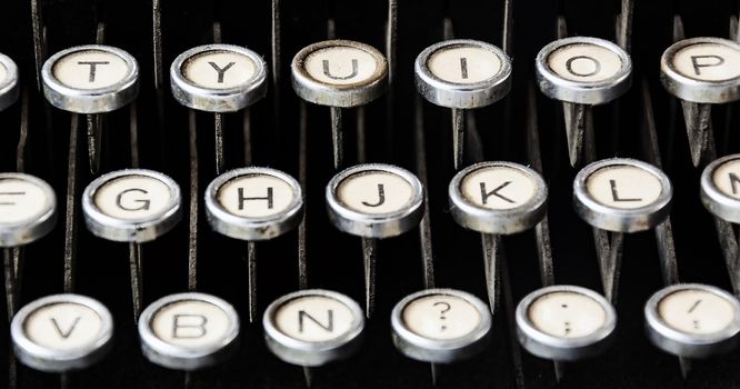 Close up view of round keys of an old typewriter. Mechanical tools for writing. Old time journalism