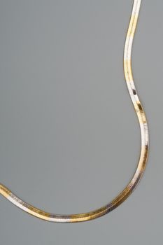 Luxury golden necklace on gray background